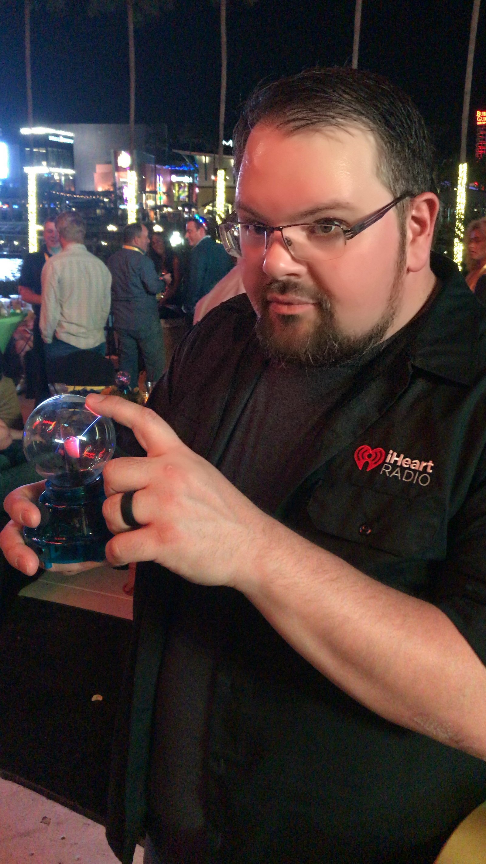 Bryan holding a plasma ball while wearing an iHeartRadio shirt