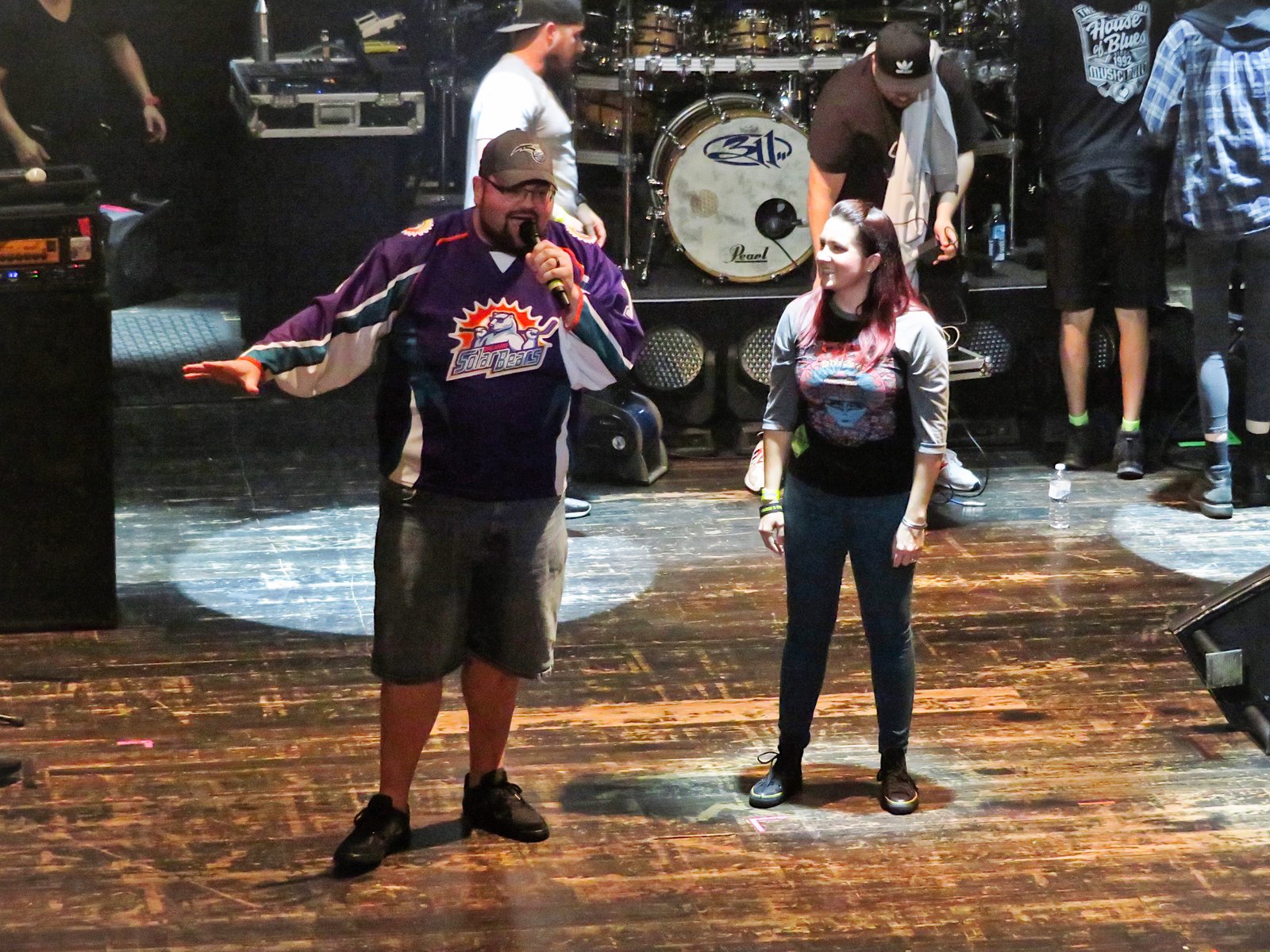 Bryan on stage with a fan in front of 311's drum kit at House of Blues