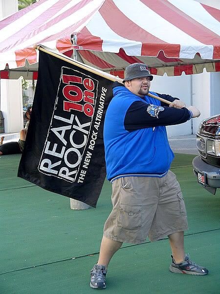 Bryan waving a Real Rock 101.1 flag at a Tampa event