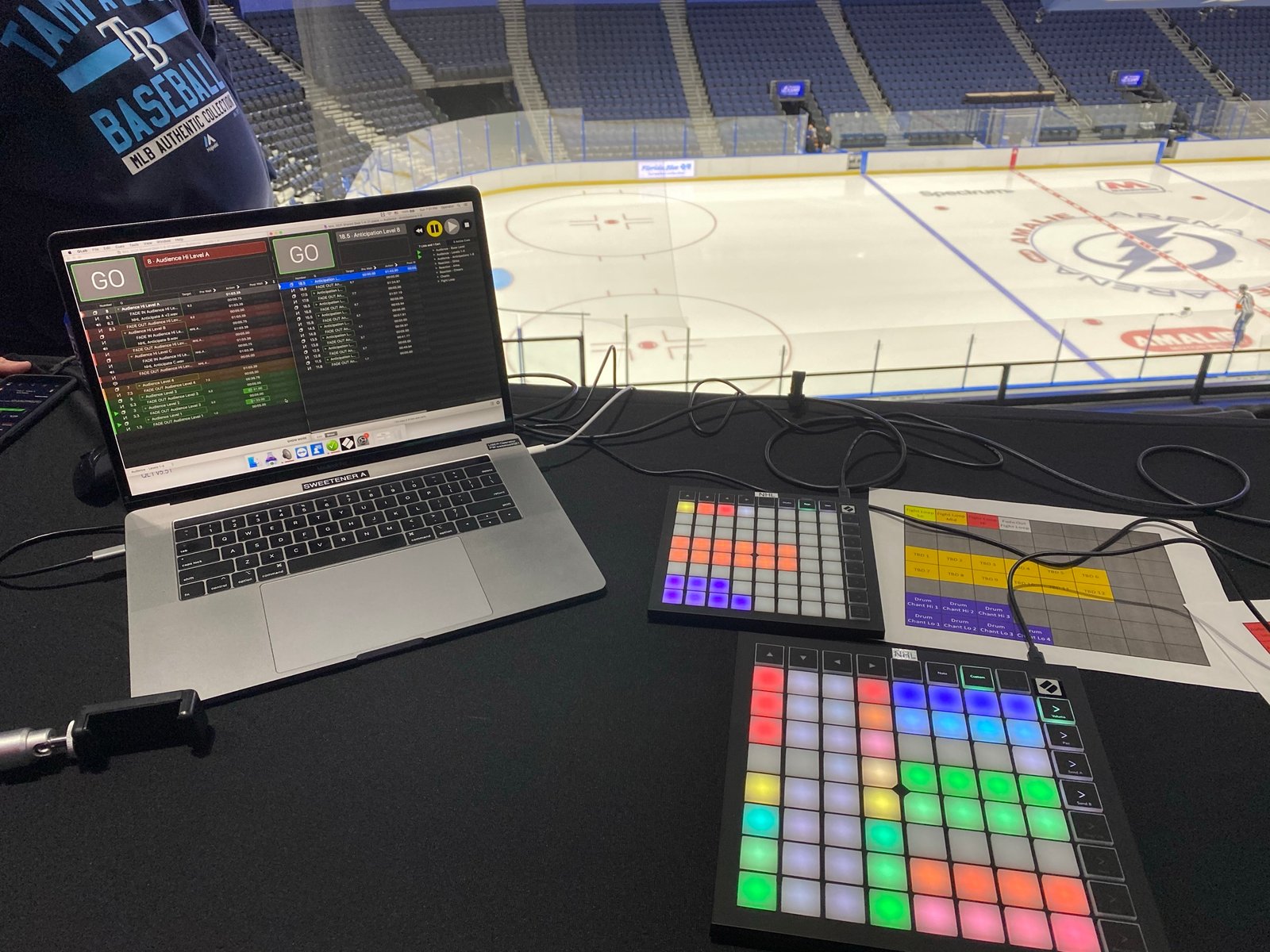 QLab audio cue laptop setup with the Tampa Bay Lightning ice and center logo in the background