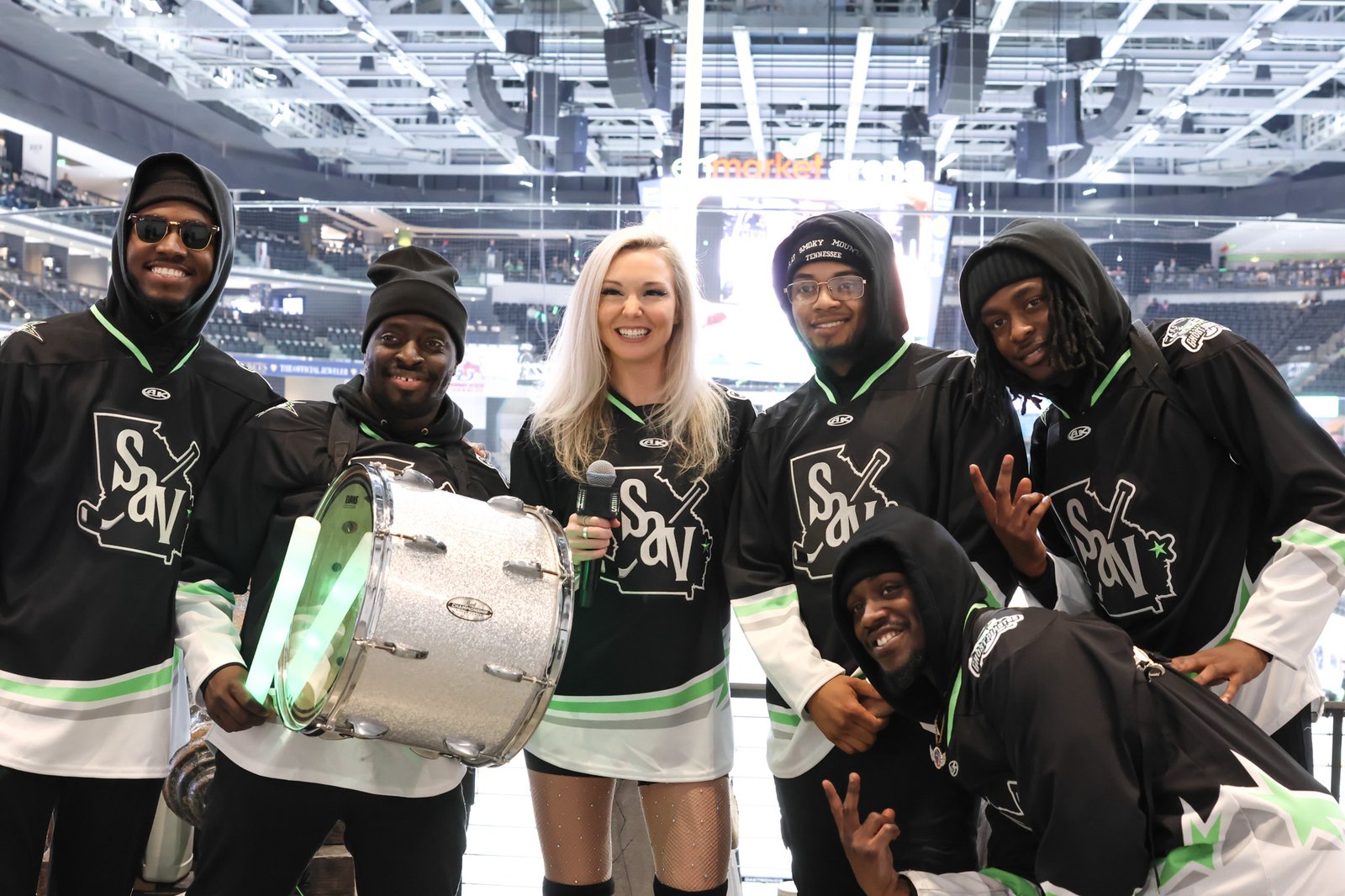 GPTV drum line crew backstage with a host holding a microphone