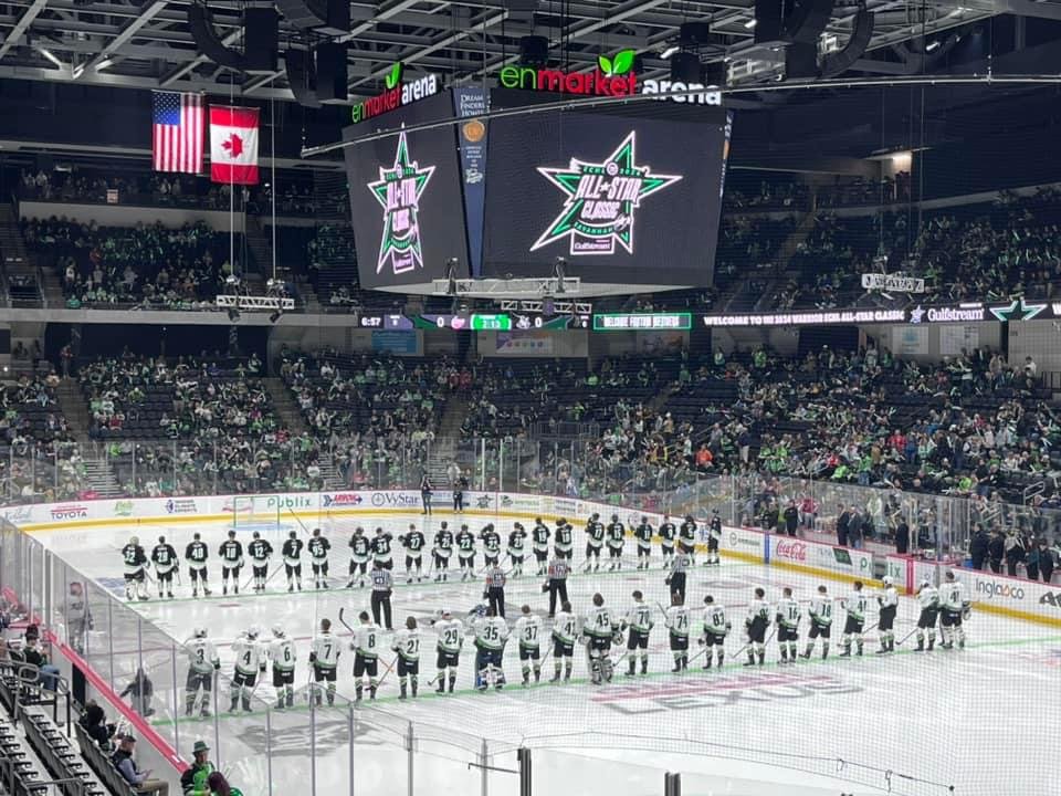 Teams lined up on the ice beneath the All-Star Classic scoreboard graphic