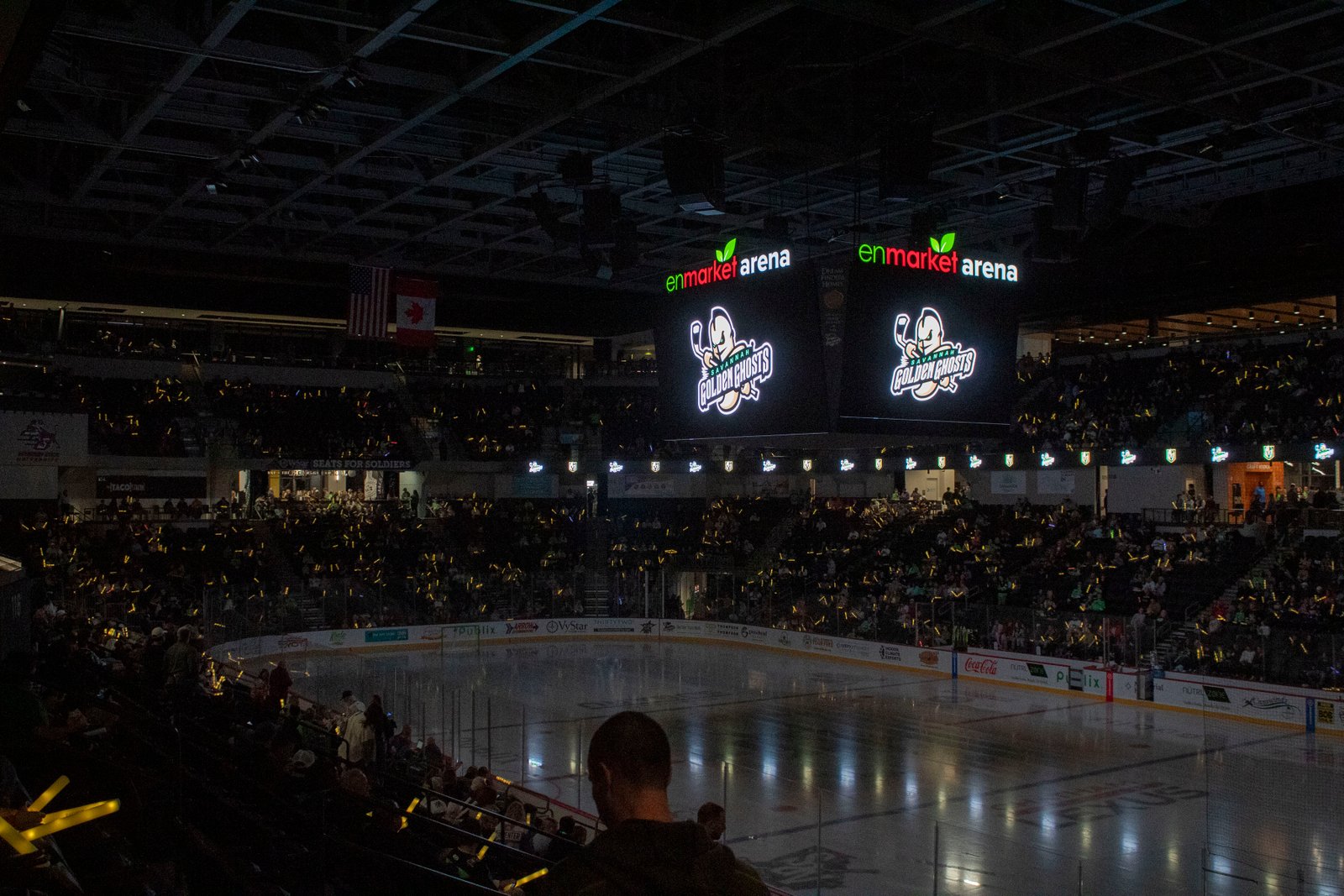 Young fans in Golden Ghosts jerseys cheering from the crowd